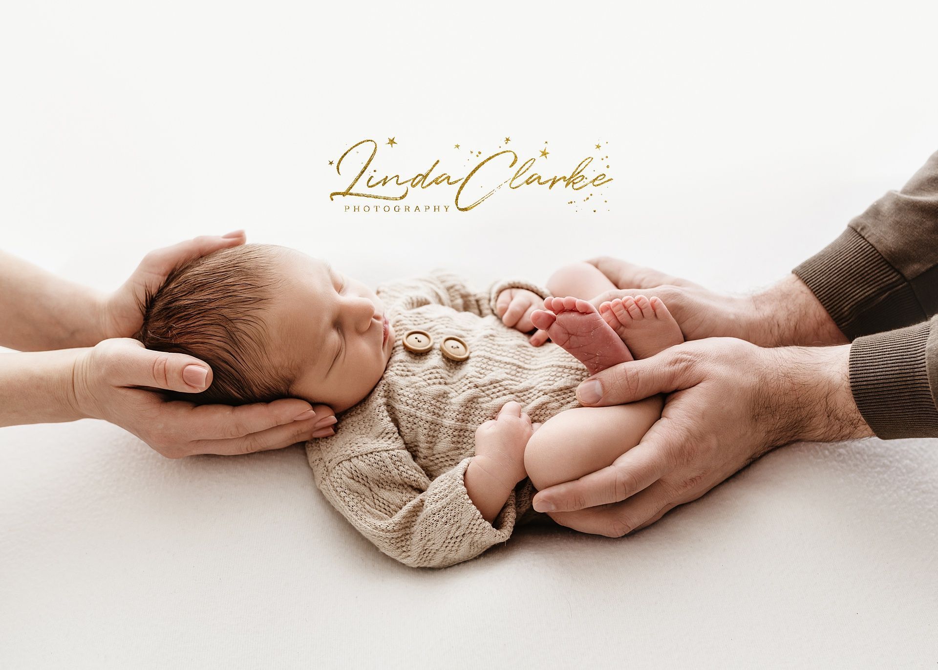 Newborn baby with parents hands during a newborn photoshoot in dublin Ireland