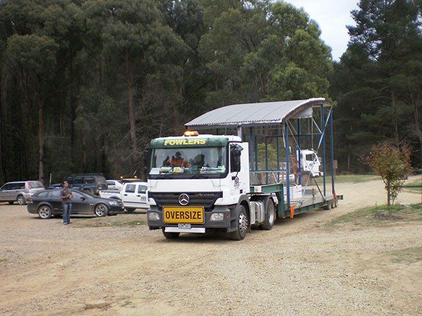 truck pulling a building