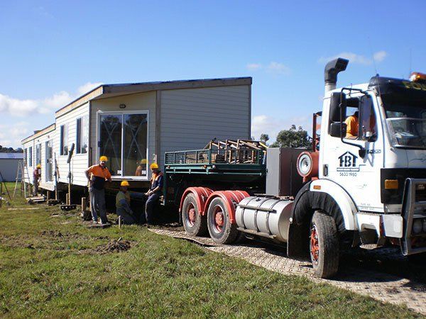truck pulling house