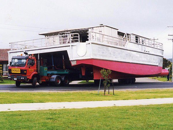 large boat being moved by truck