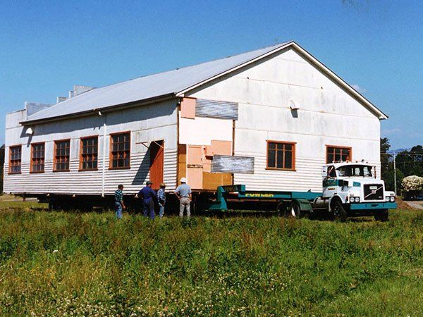 vintage building being moved by truck