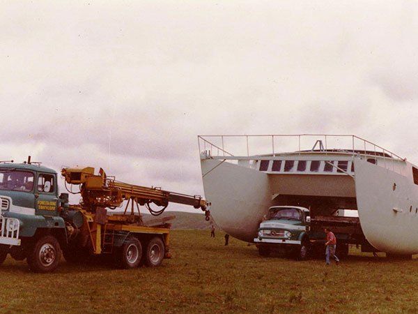 large boat on vintage moving truck