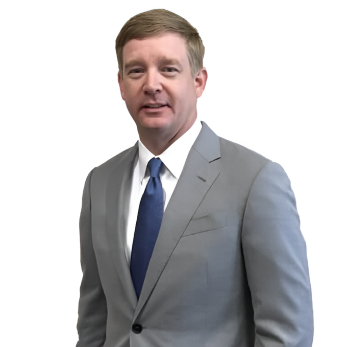 Man in a light gray suit and blue tie against a white background