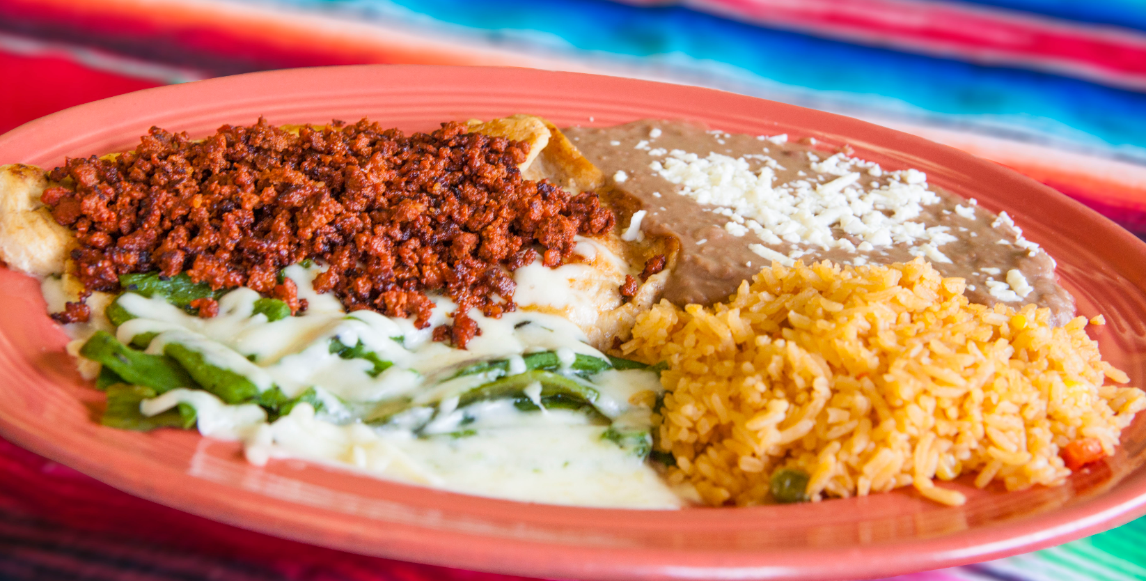 A close up of a plate of mexican food on a table.