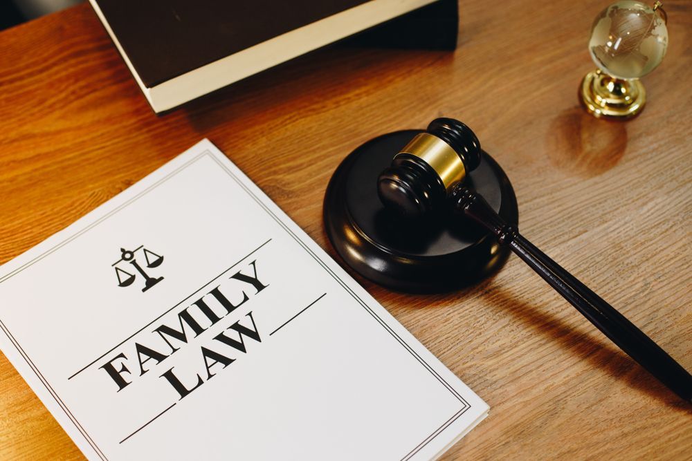 A Judge's Gavel Is Sitting On A Wooden Table Next To A Book About Family Law — SJP Law In Maroochydore, QLD