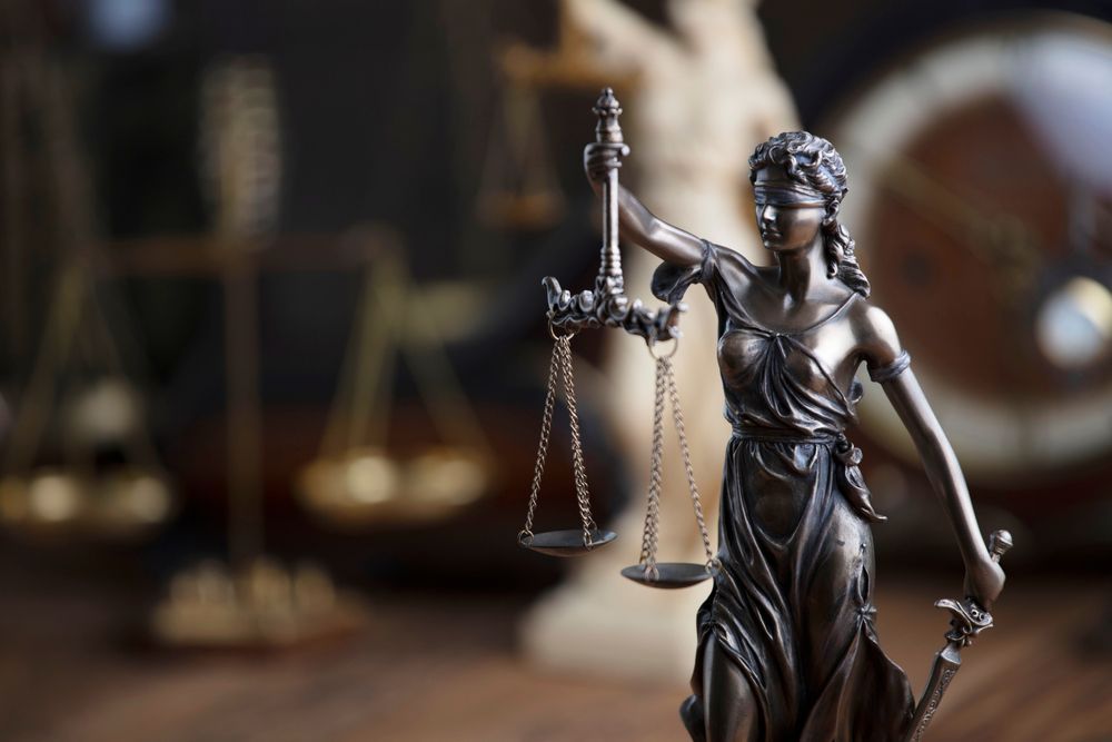 A Statue Of Lady Justice Holding Scales And A Sword — SJP Law In Maroochydore, QLD