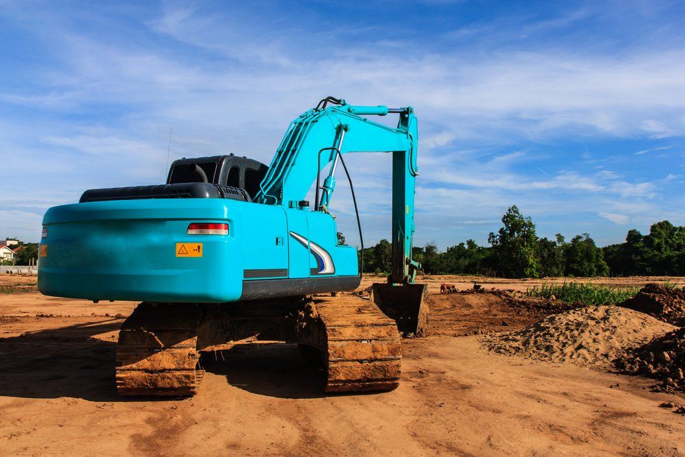 Blue Heavy Machinery Excavating the Land — Satts Plant Hire & Haulage in Dubbo, NSW