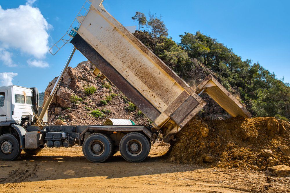 Truck Unloading the Soil — Satts Plant Hire & Haulage in Parkes, NSW