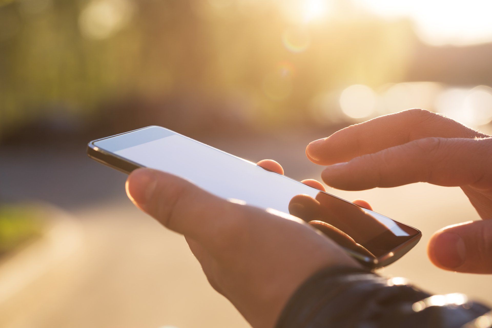 Man Using His Phone — Racine, WI — J & F Auto Glass