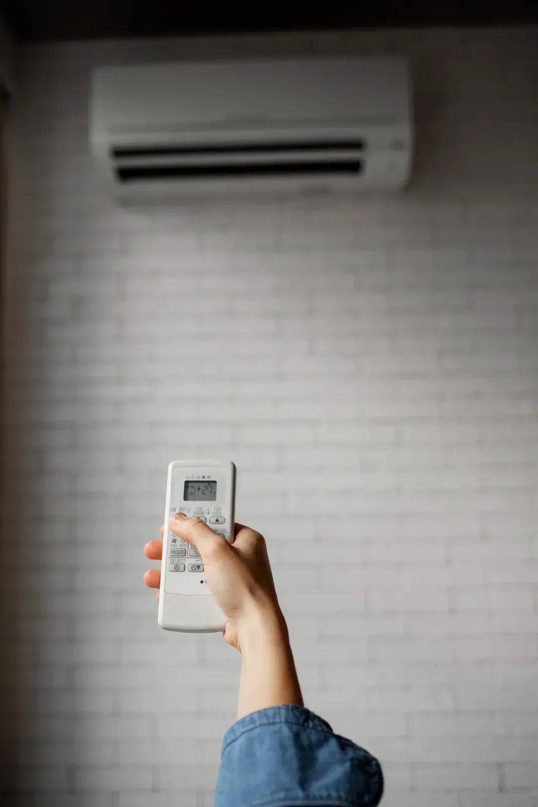 Person Holding Remote Control — KACE Electrical Solutions In Ramsay, QLD