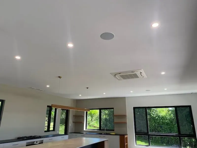 Bright White Ceiling With Recessed Lights, an Air Vent, and a Speaker — KACE Electrical Solutions In Ramsay, QLD