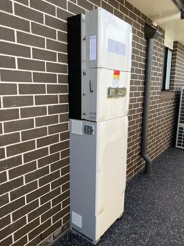 White and Grey Solar Panel Inverter Mounted on a Brick Wall — KACE Electrical Solutions In Ramsay, QLD