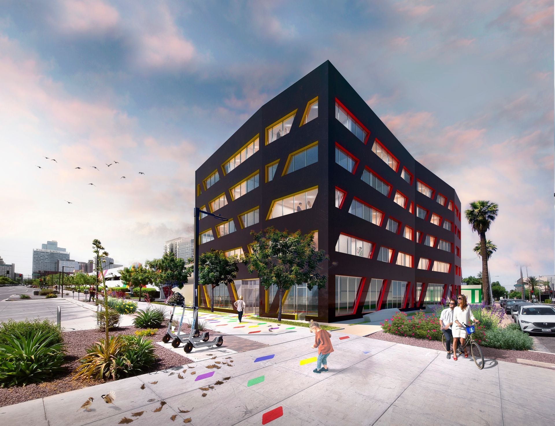 Modern black building with colorful window frames, pedestrians on a walkway, trees, and sky.