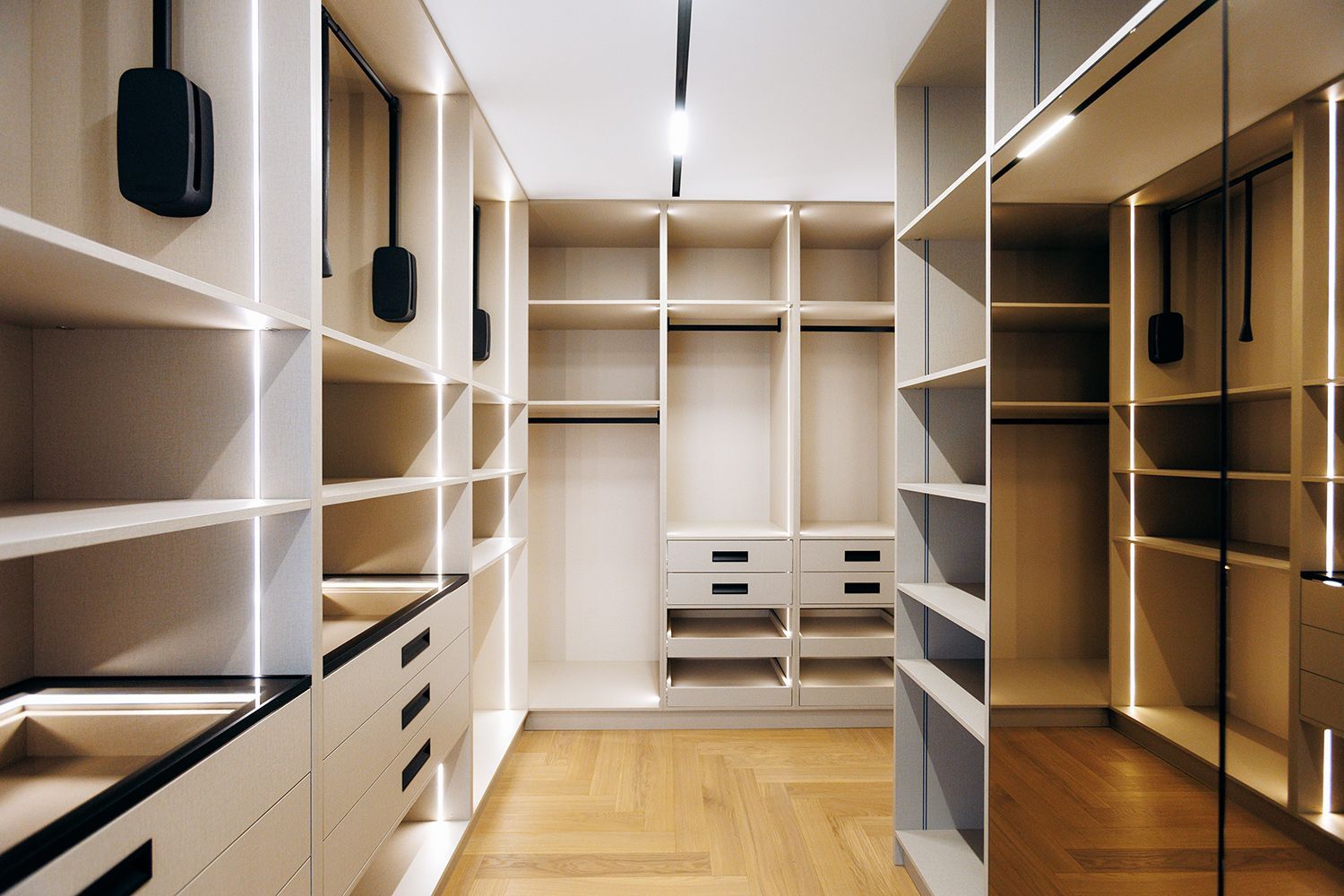 Custom-built wardrobe with tailored cabinetry and built-in lighting.