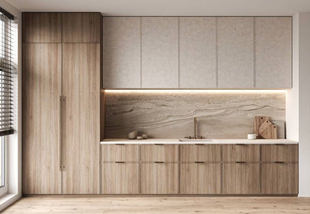 A modern kitchen with wooden custom cabinetry, integrated appliances, and a sandstone backsplash.