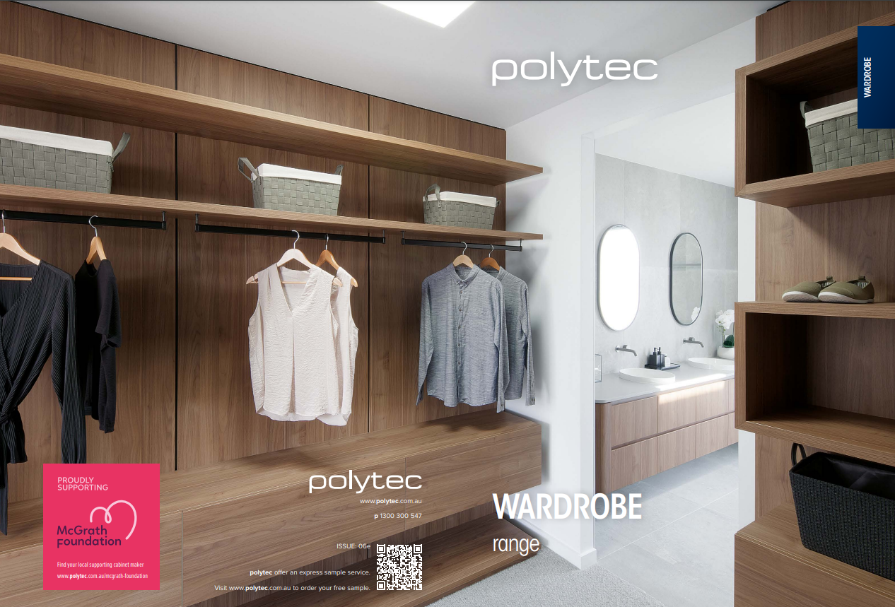 A walk in closet with clothes hanging on shelves and a bathroom