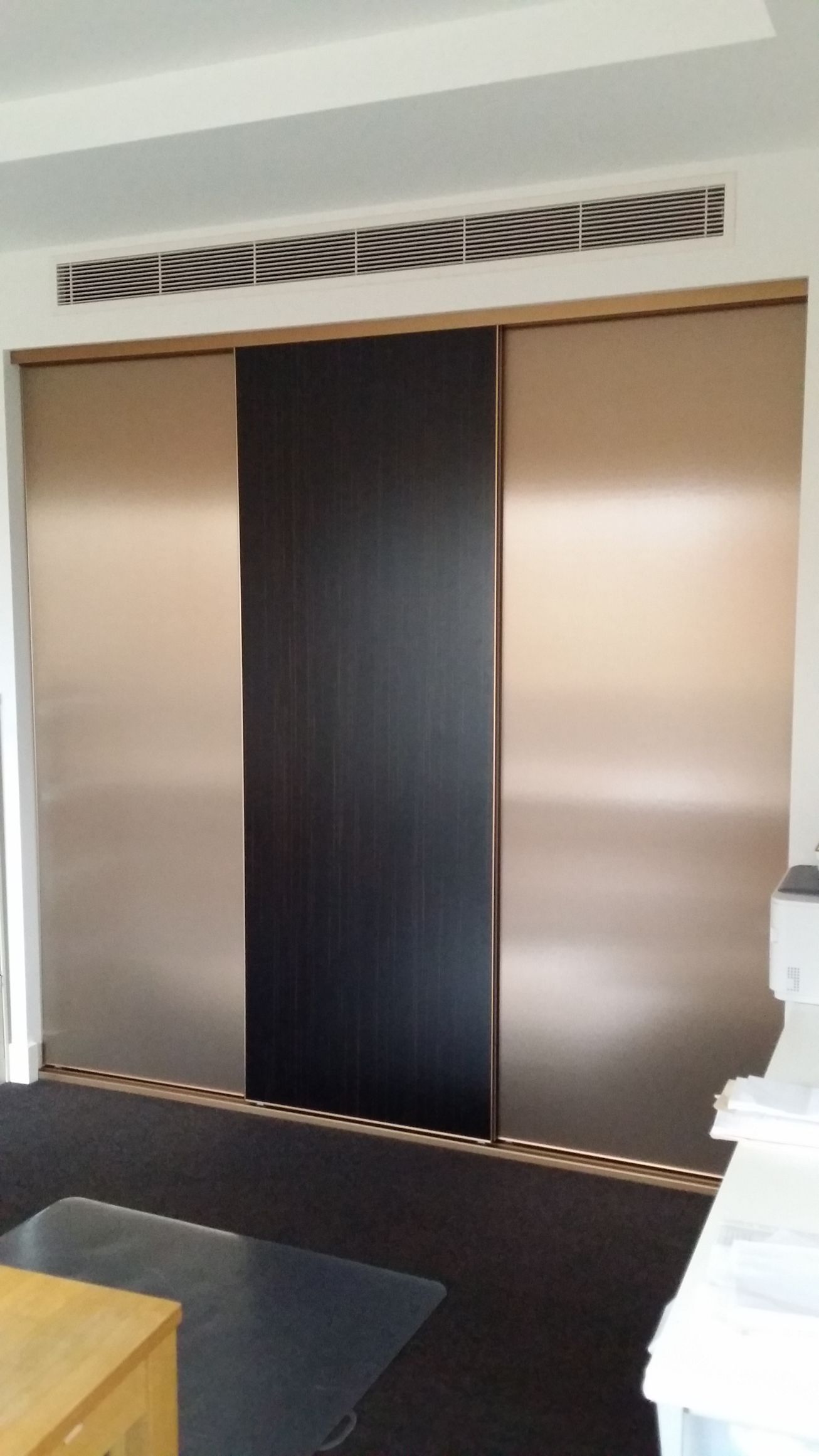 A room with sliding doors and a ceiling fan