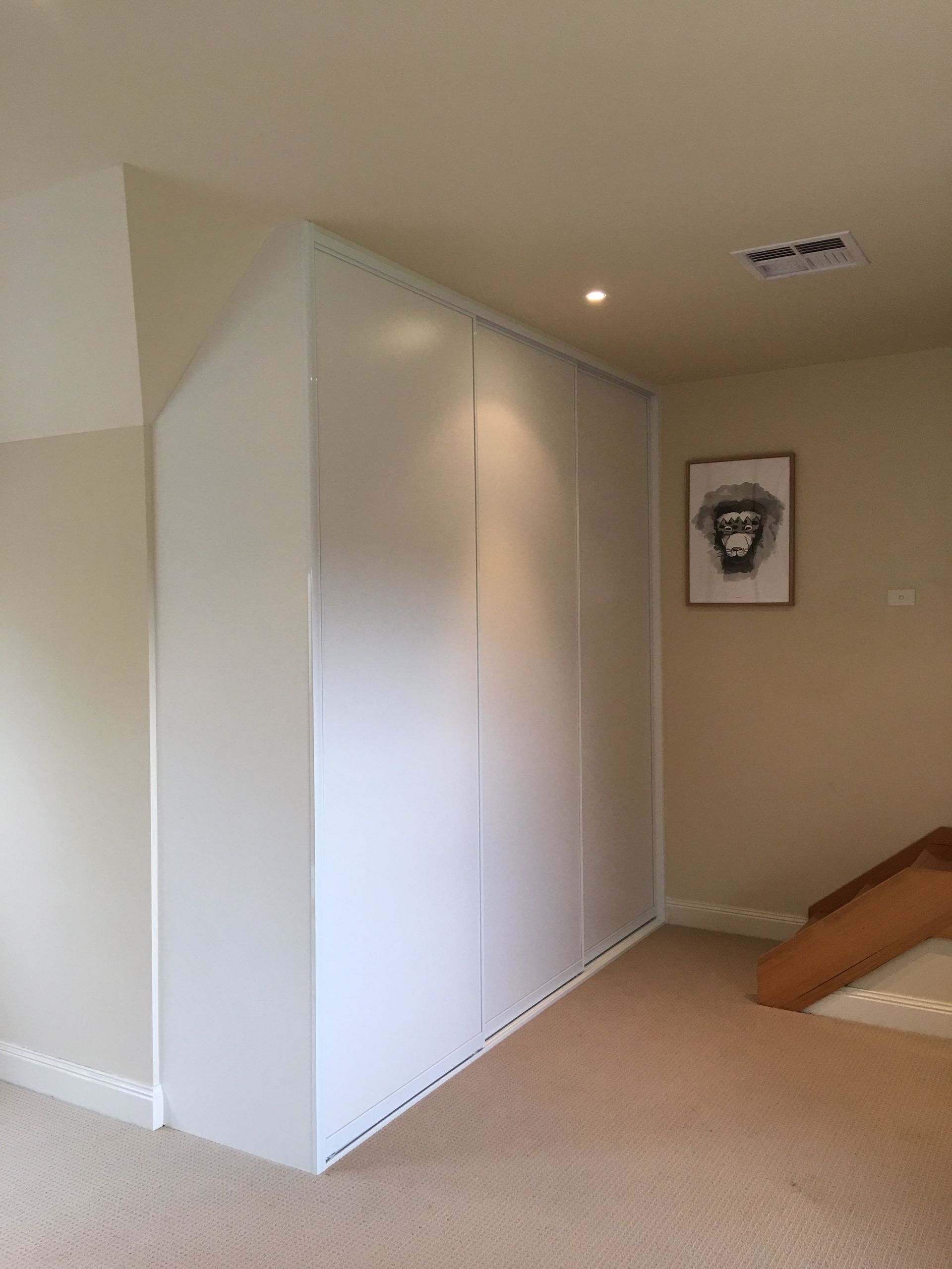 There is a picture of a monkey on the wall above the stairs.