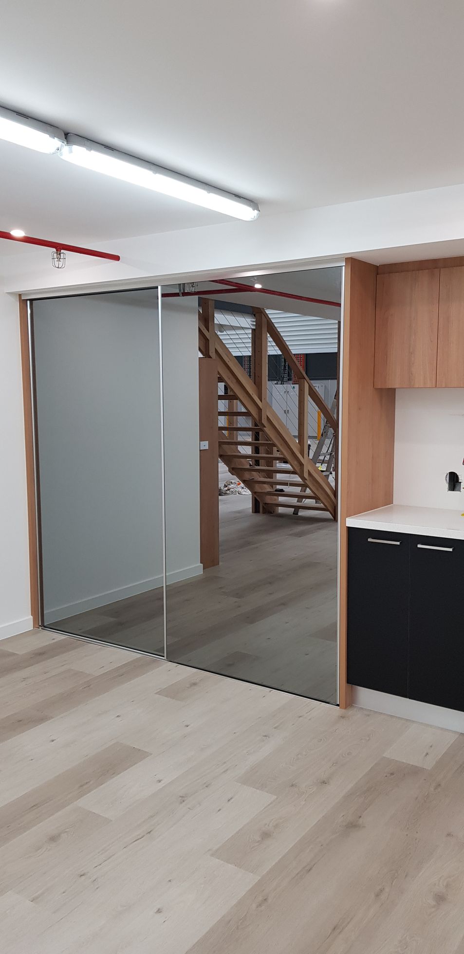 There is a staircase in the background of the room.