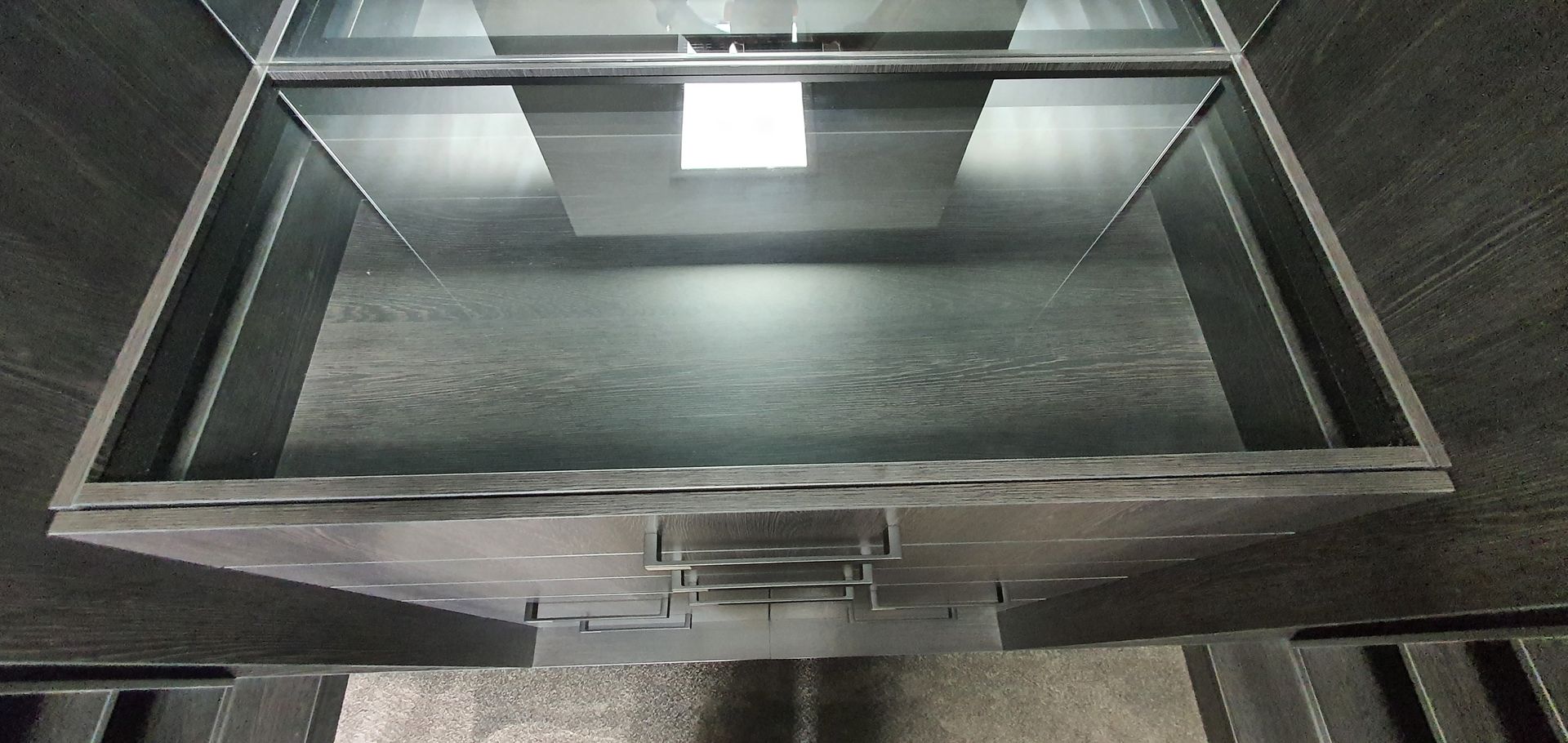 A metal box with a handle and a light inside of it