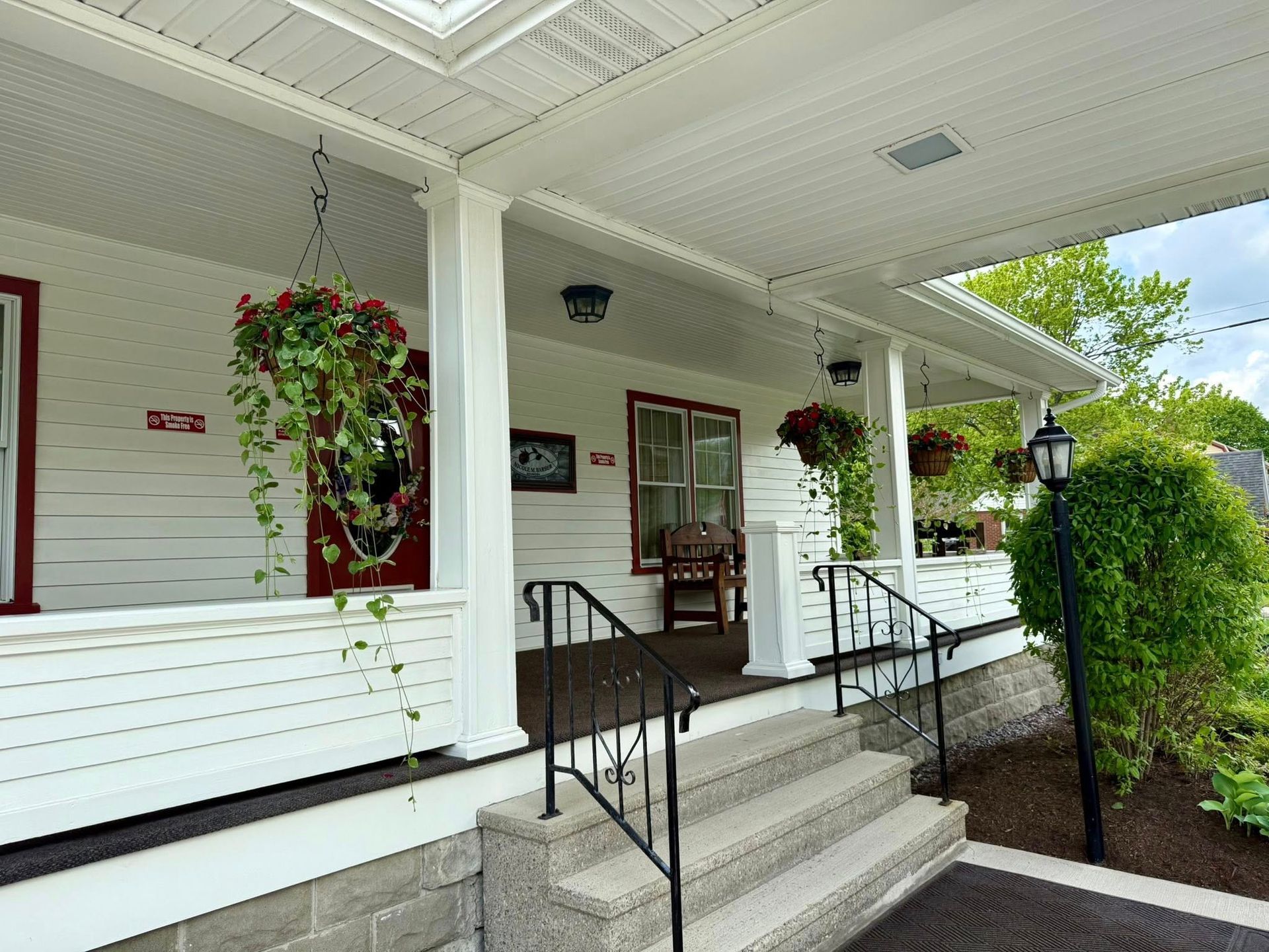A white house with a porch and stairs
