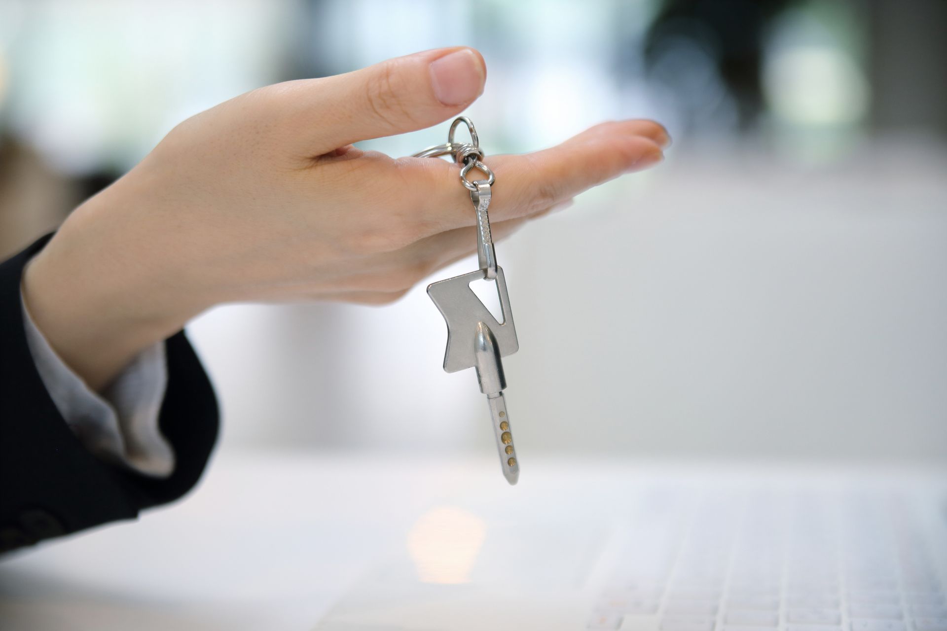 A close-up of an individual holding a key, showcasing the importance of commercial re-keys. A close-up of an individual holding a key, showcasing the importance of commercial re-keys.