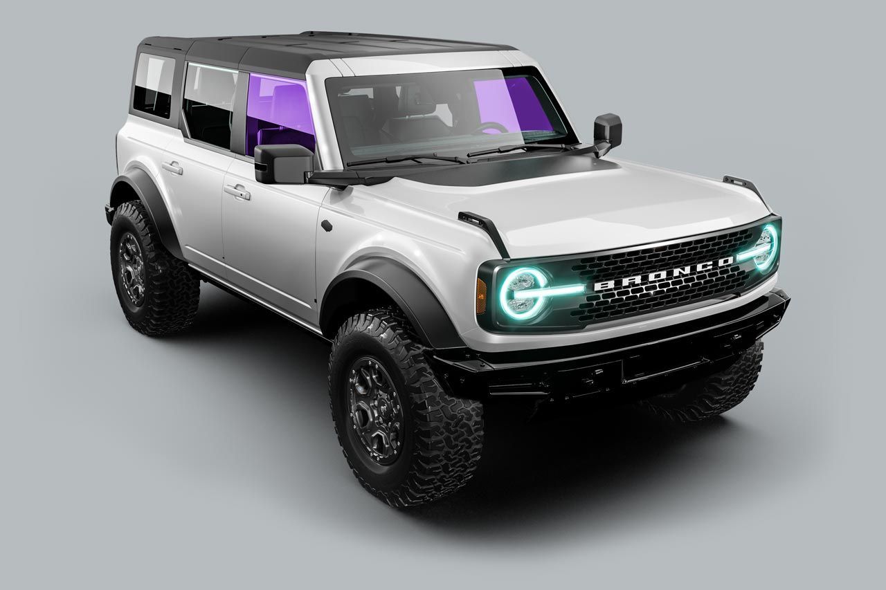 A white ford bronco is sitting on a gray surface.