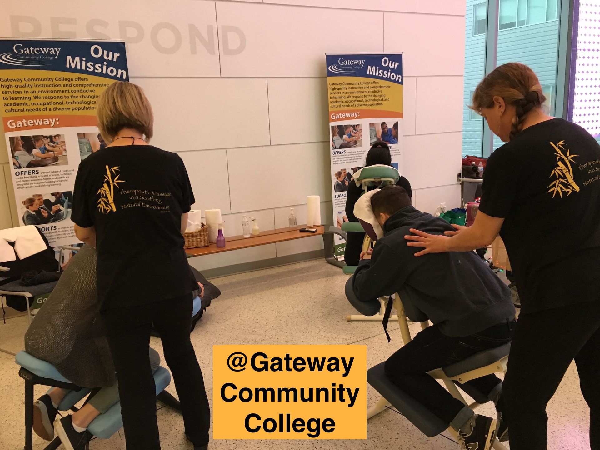 Two people giving a massage at gateway community college
