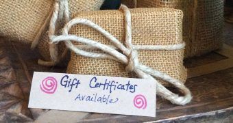 A gift certificate is wrapped in burlap and tied with string.