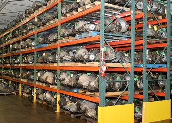 A large warehouse filled with lots of parts on shelves.