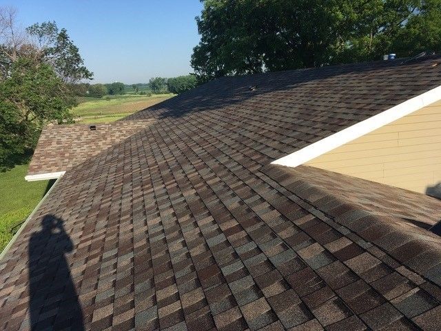 A man is working on a roof with a hammer