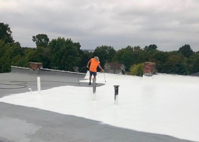 An aerial view of a building under construction with a chimney on the roof.