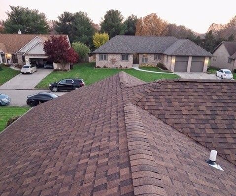 A man is working on the roof of a building.