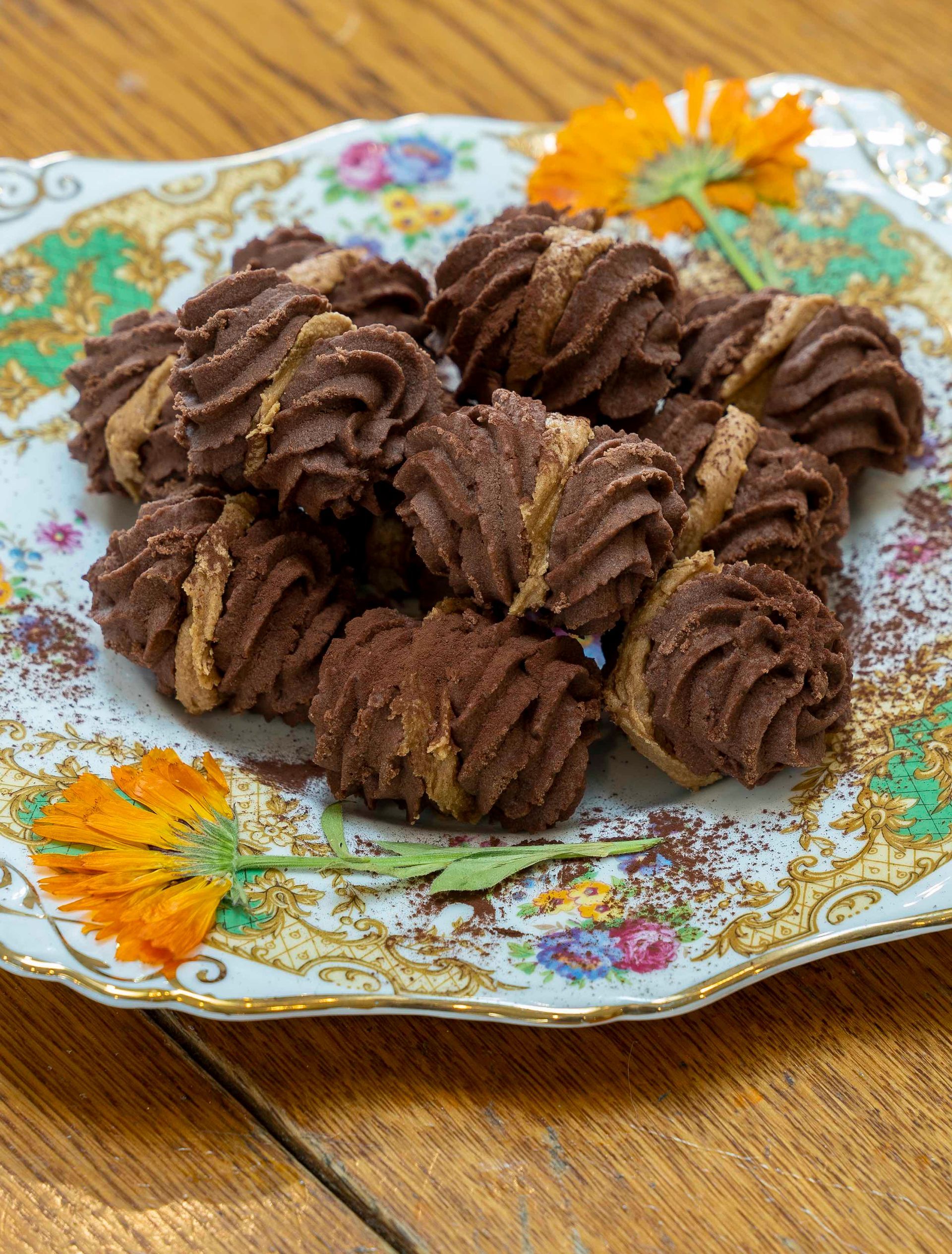 A plate of chocolate cookies on a wooden table.