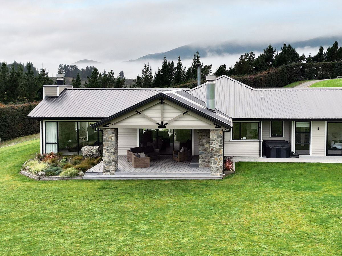 A large house with a large lawn in front of it.