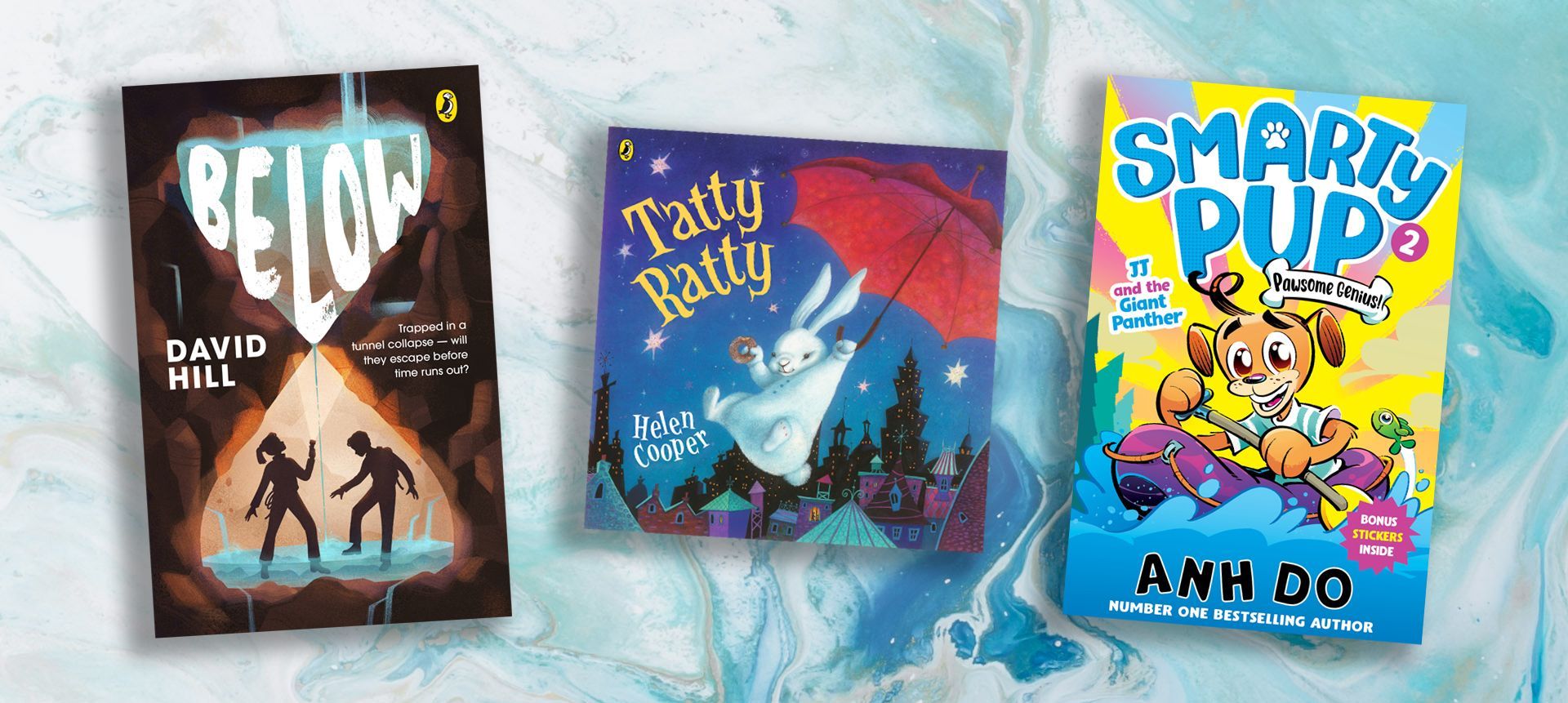 Three children 's books are lined up on a table.