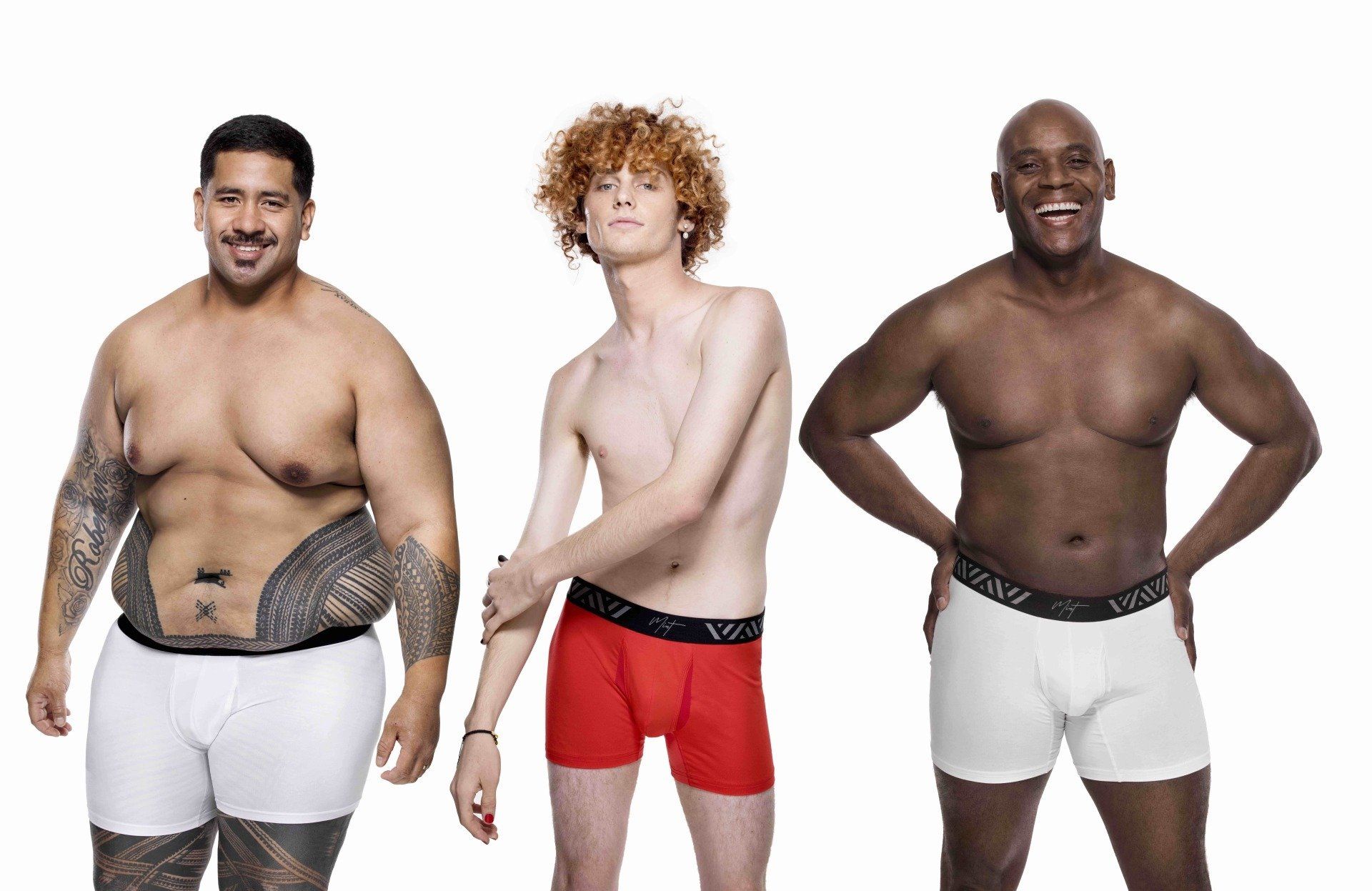 Three men are standing next to each other in underwear.