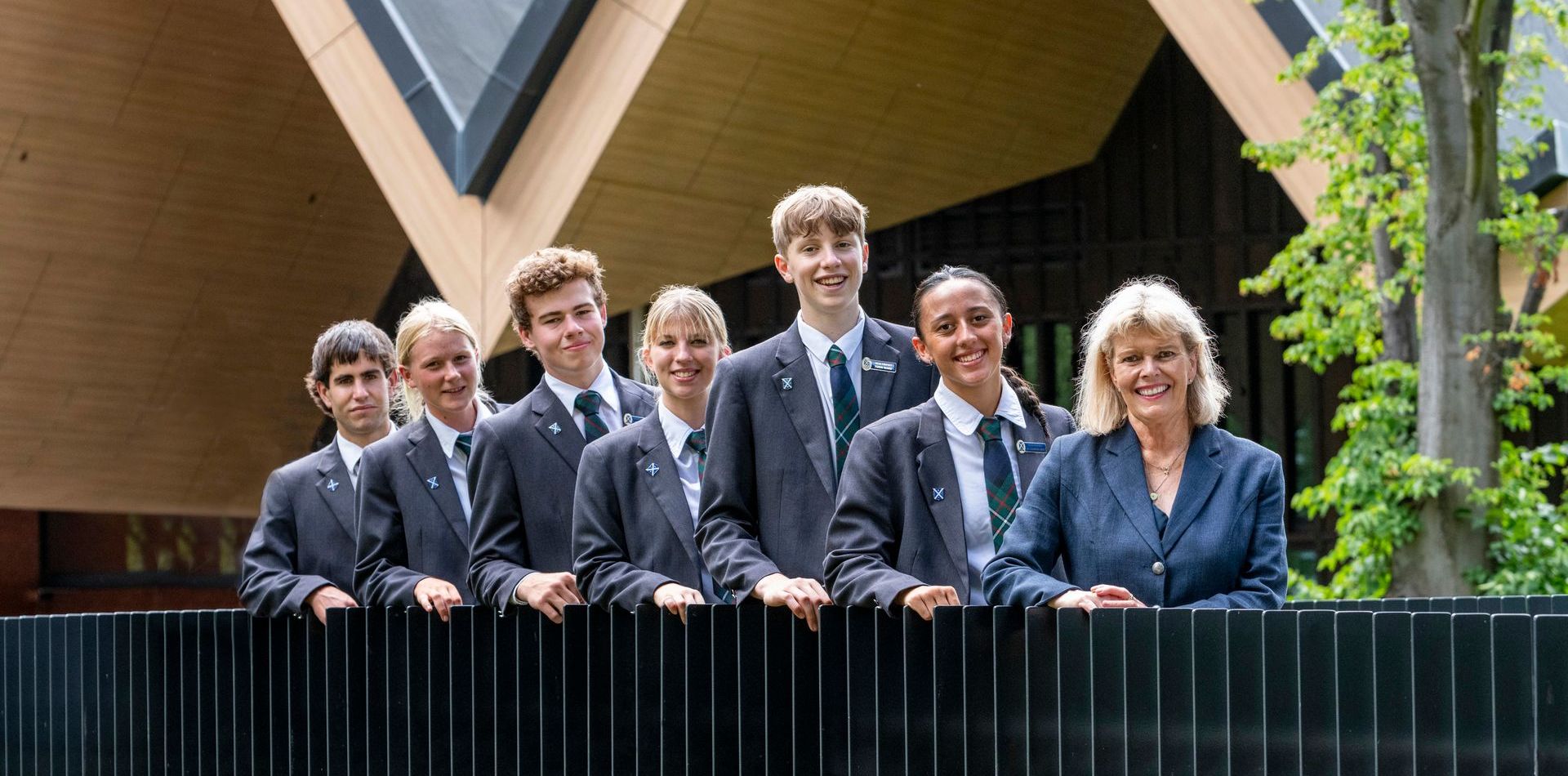 A group of people in suits and ties are posing for a picture.