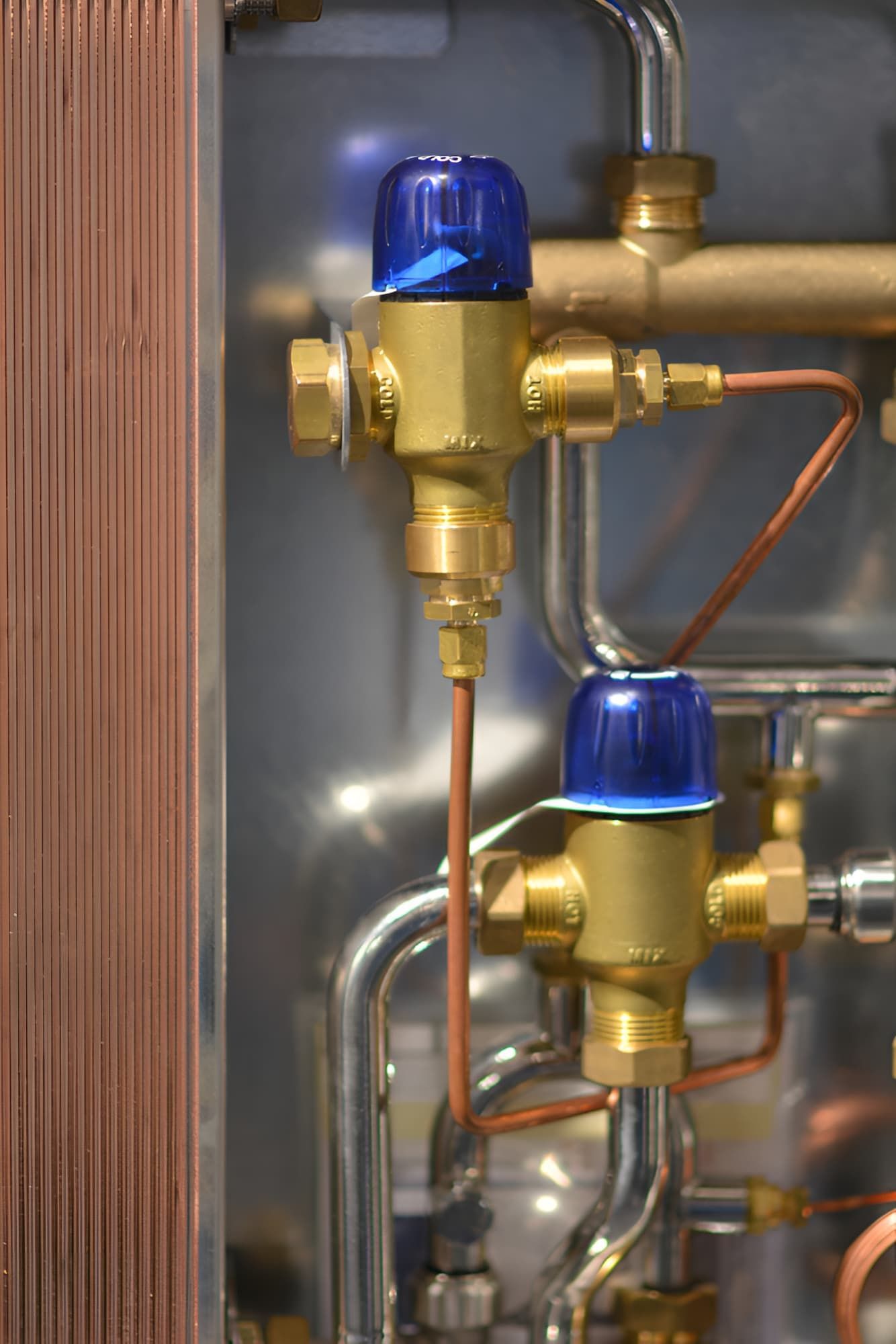 A Close Up of a Valve and Copper Pipes in a Machine — Simpson's Plumbing & Maintenance Service in Morayfield, QLD