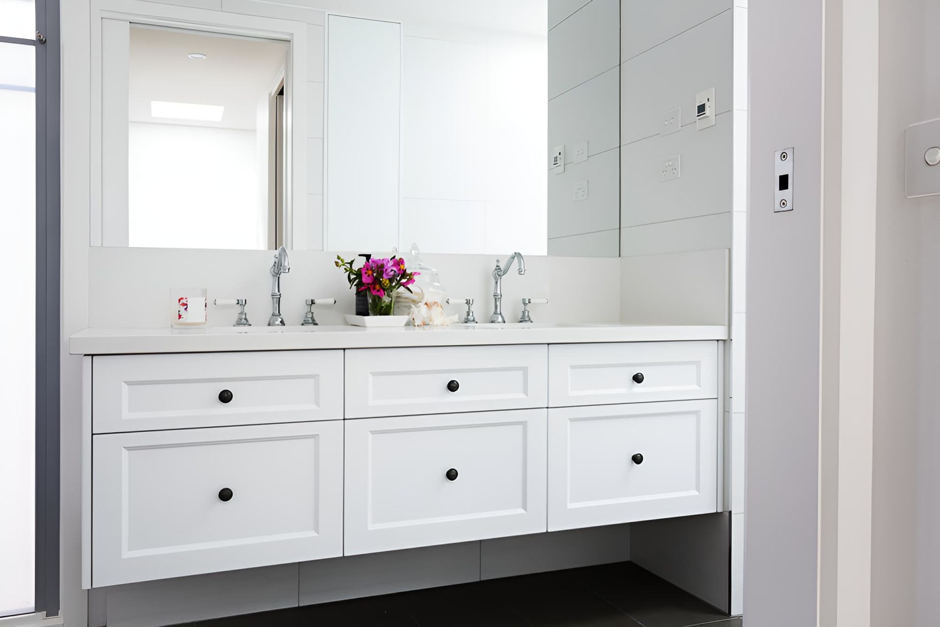 A Bathroom With Two Sinks and a Mirror — Simpson's Plumbing & Maintenance Service in Kallangur, QLD