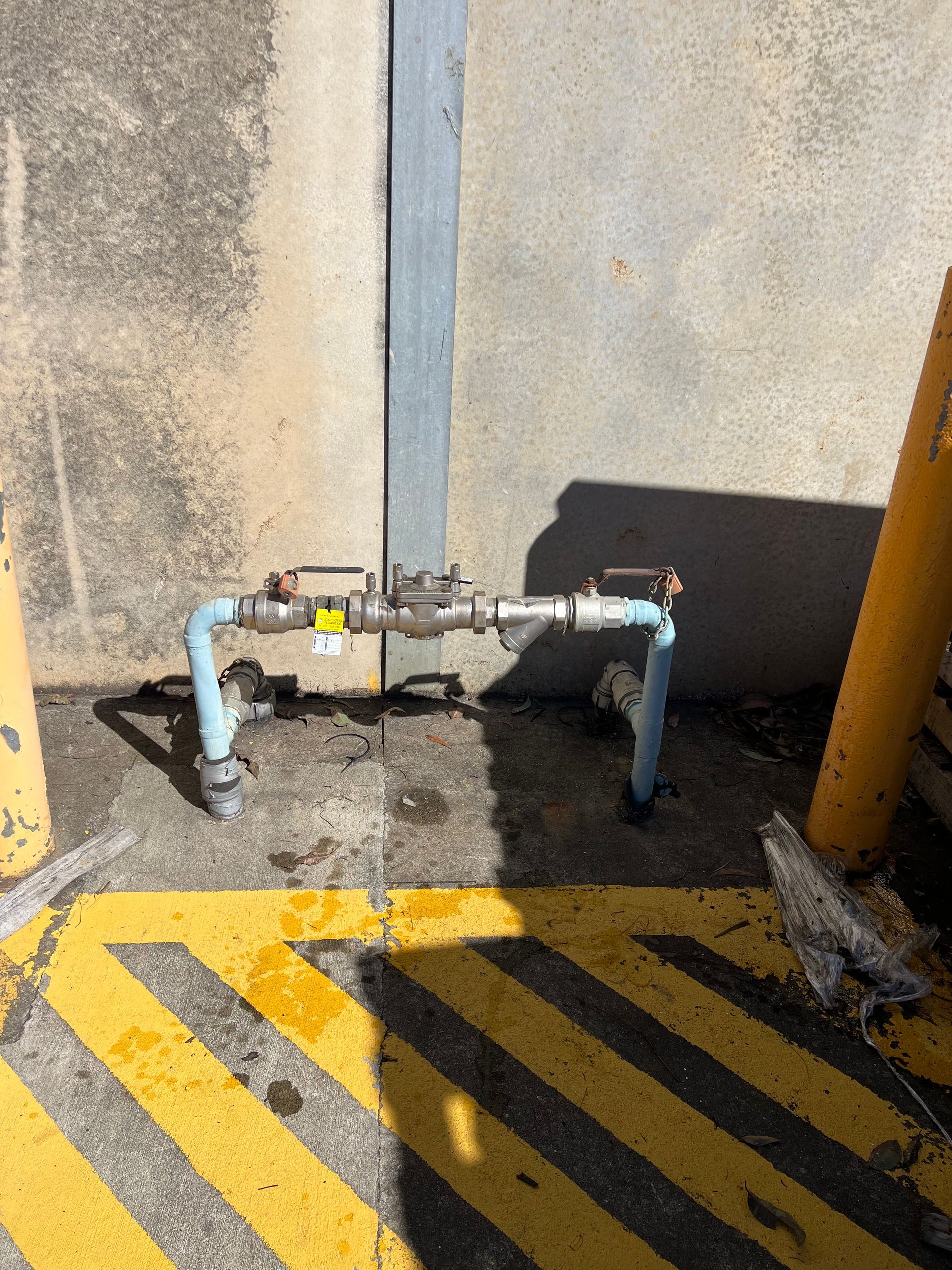 A Close Up of a Water Faucet on a White Wall — Simpson's Plumbing & Maintenance Service in Dakabin, QLD