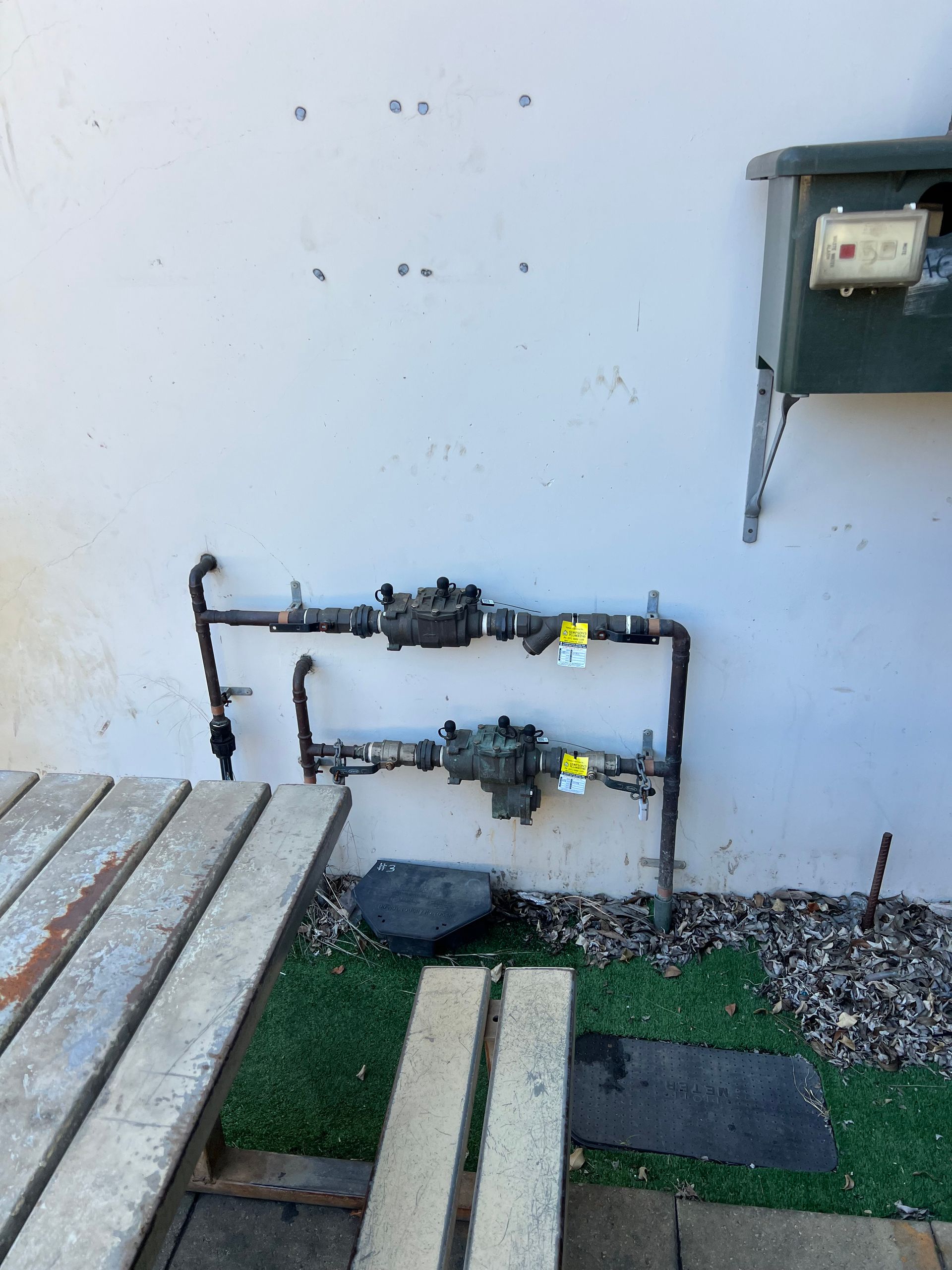 A Close Up of a Row of Pipes and Valves on a Wall — Simpson's Plumbing & Maintenance Service in Dakabin, QLD
