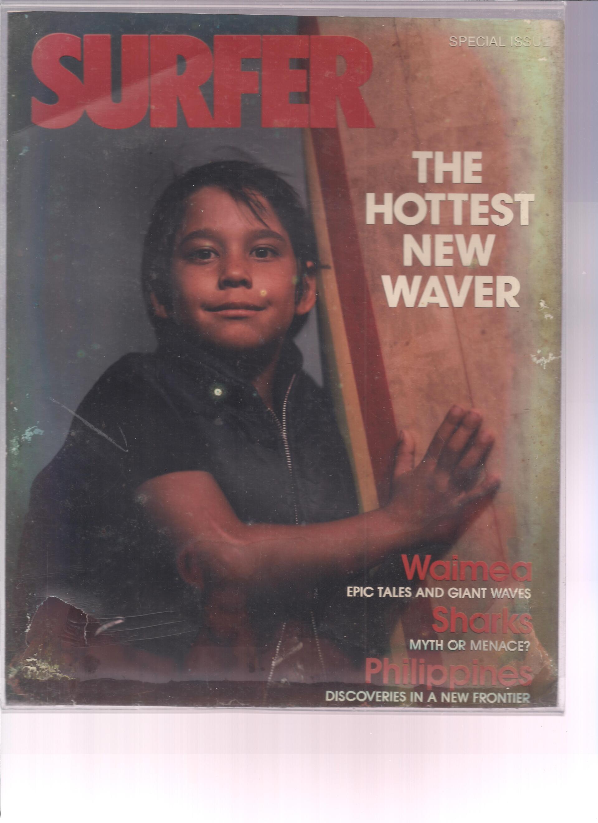 A surfer magazine with a young boy on the cover