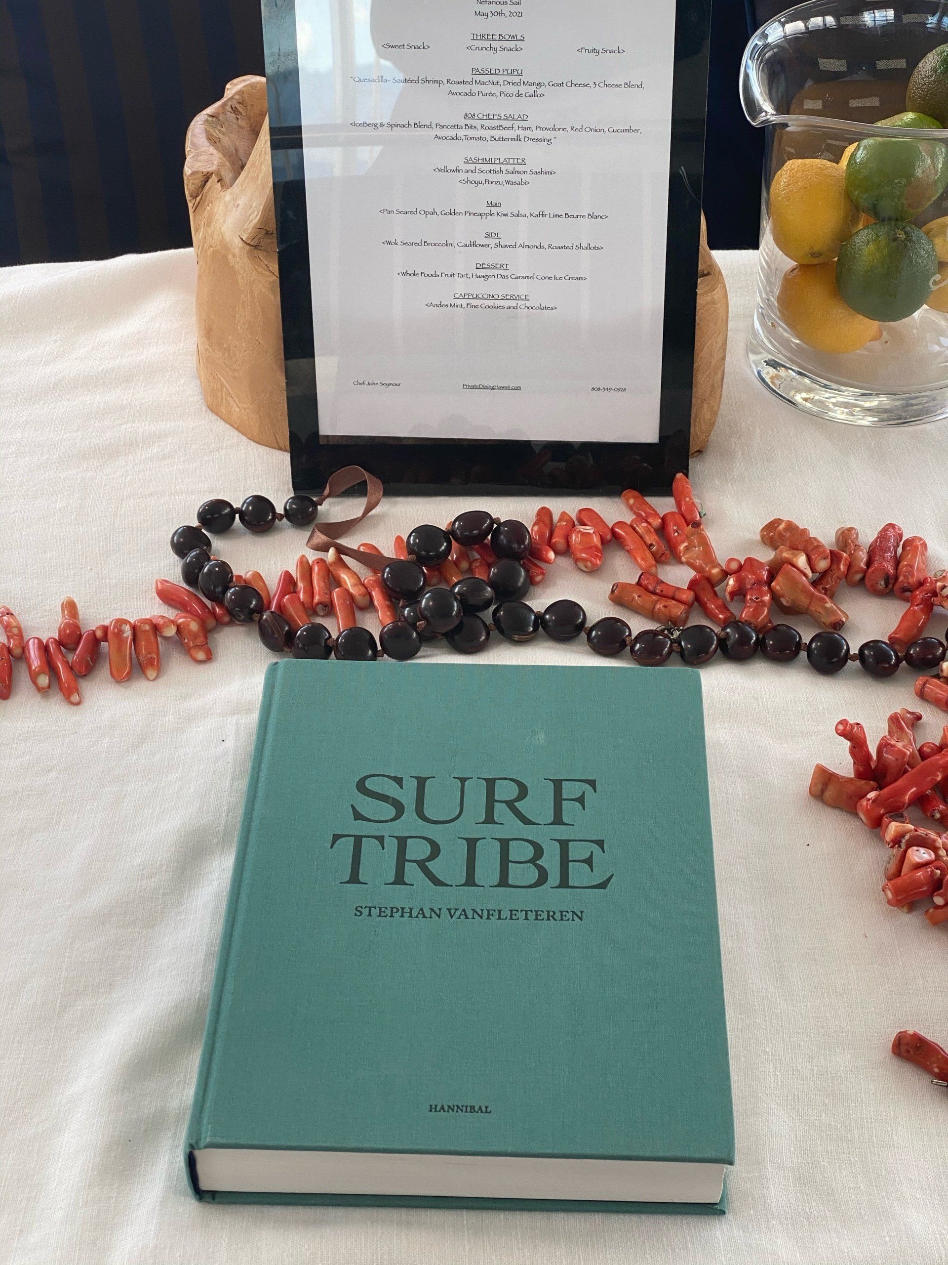 A book called surf tribe is sitting on a table