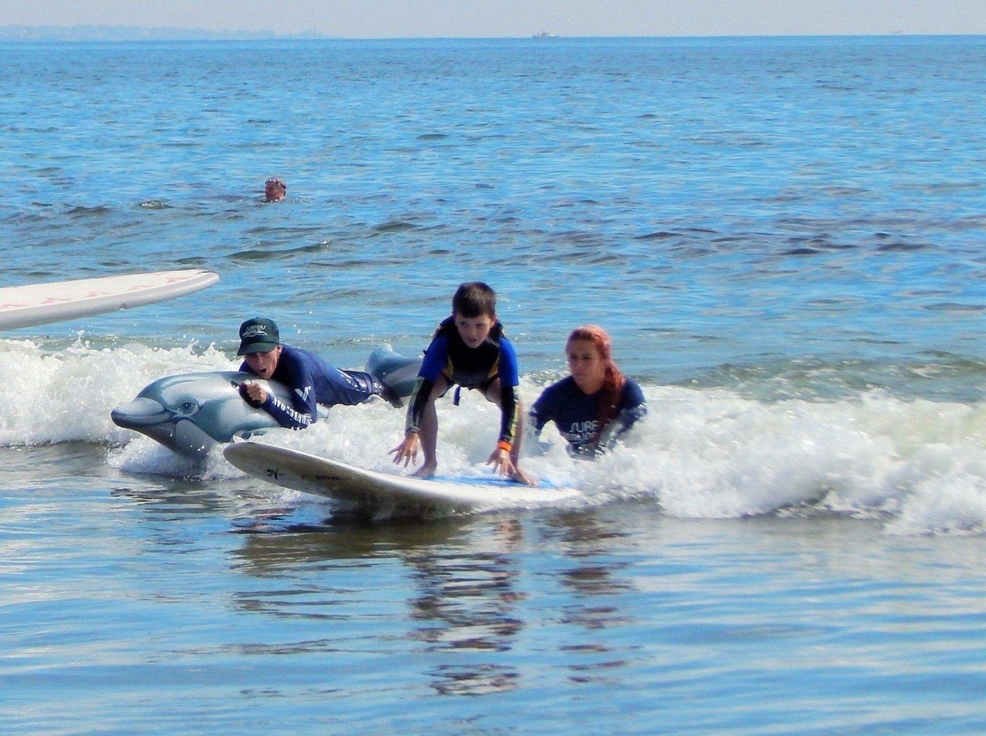 A group of people are riding waves on surfboards in the ocean.