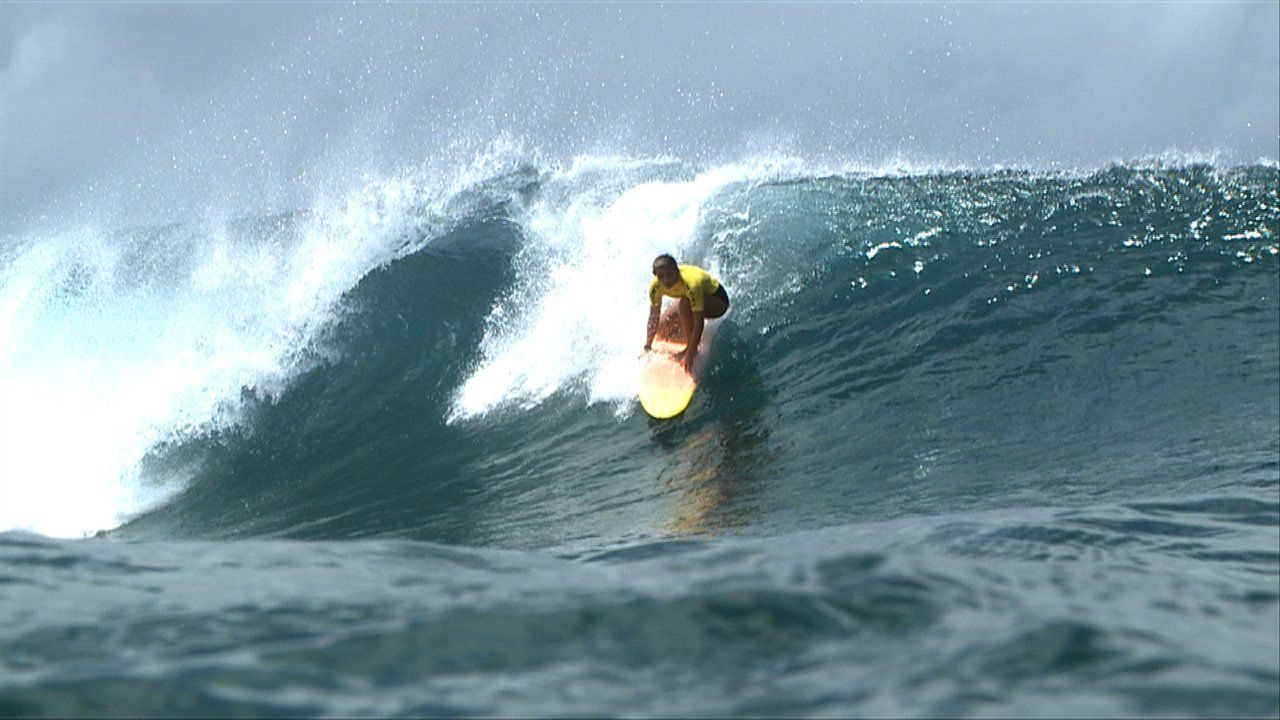 A surfer is riding a wave in the ocean