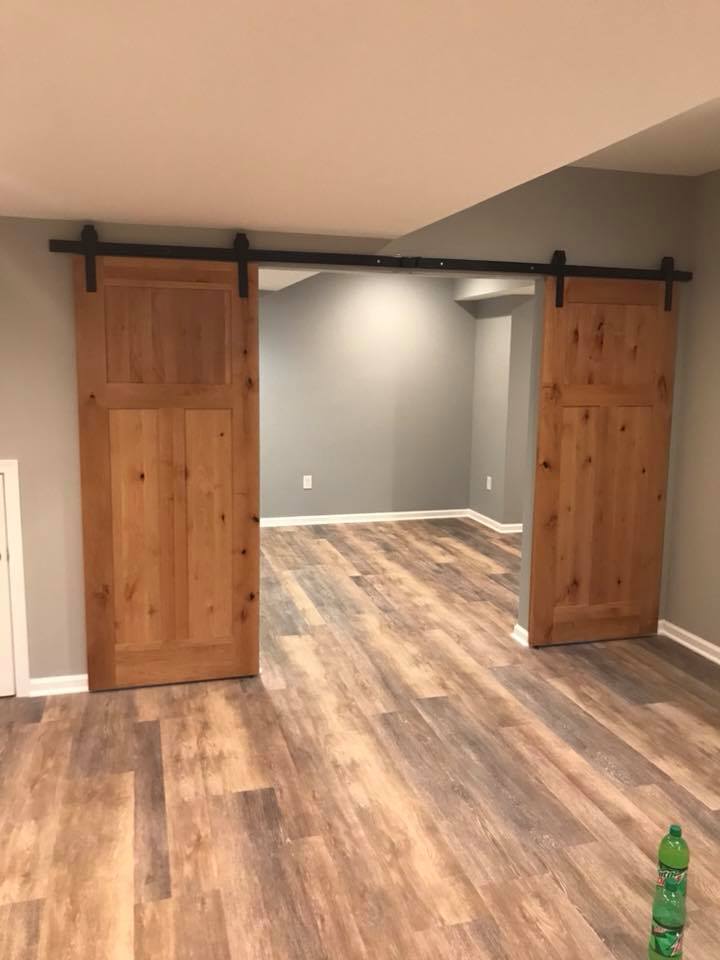 Contractor framing a new room addition onto a house