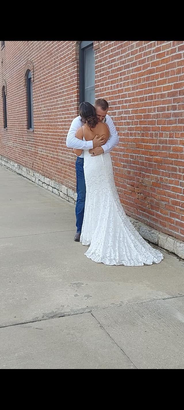 Bride and Groom outside with brick building