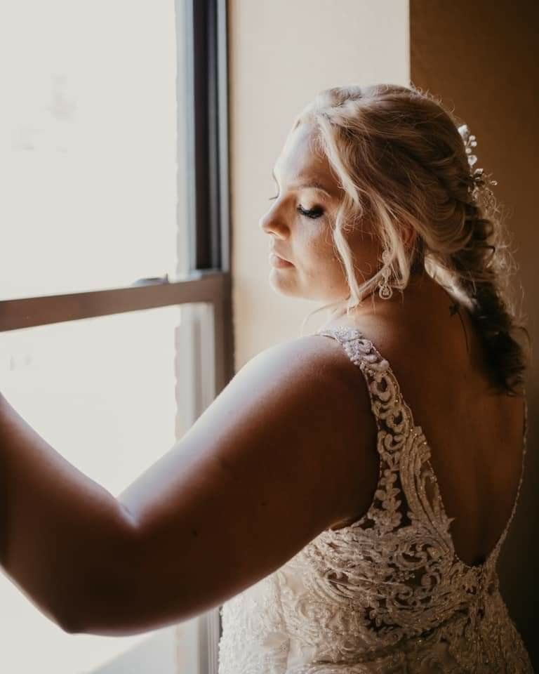Bride posing by window