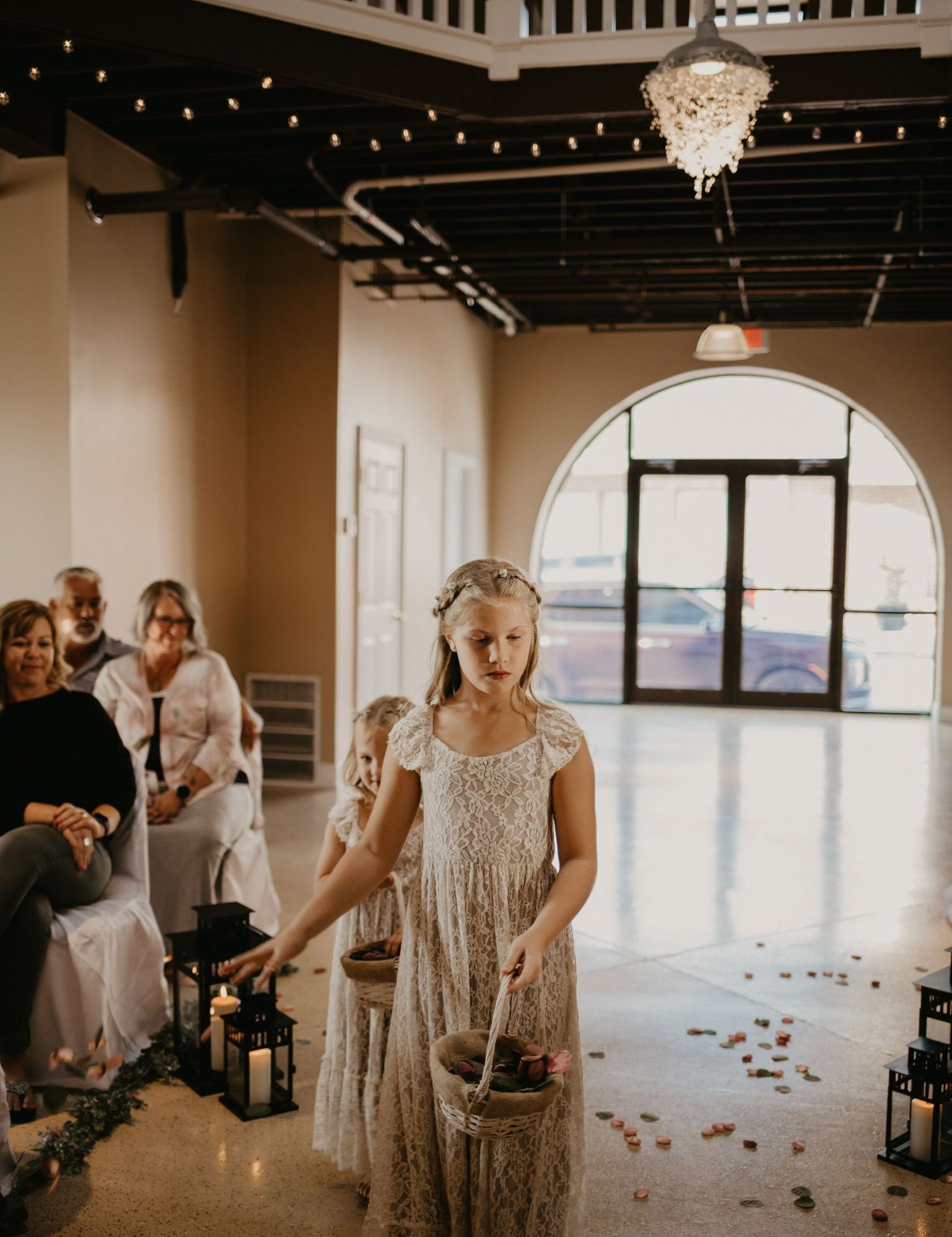 a flower girl is walking down the aisle at a wedding.